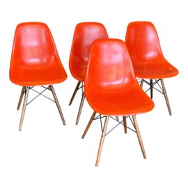 Herman Miller Eames Molded Orange Fiberglass Side Chairs + Dowel Base, a Set of Four. Original Price: $4,725